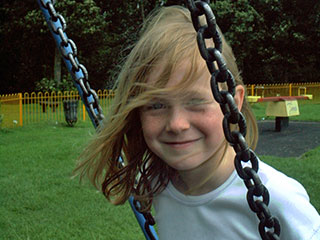 Swinging Claire in park.